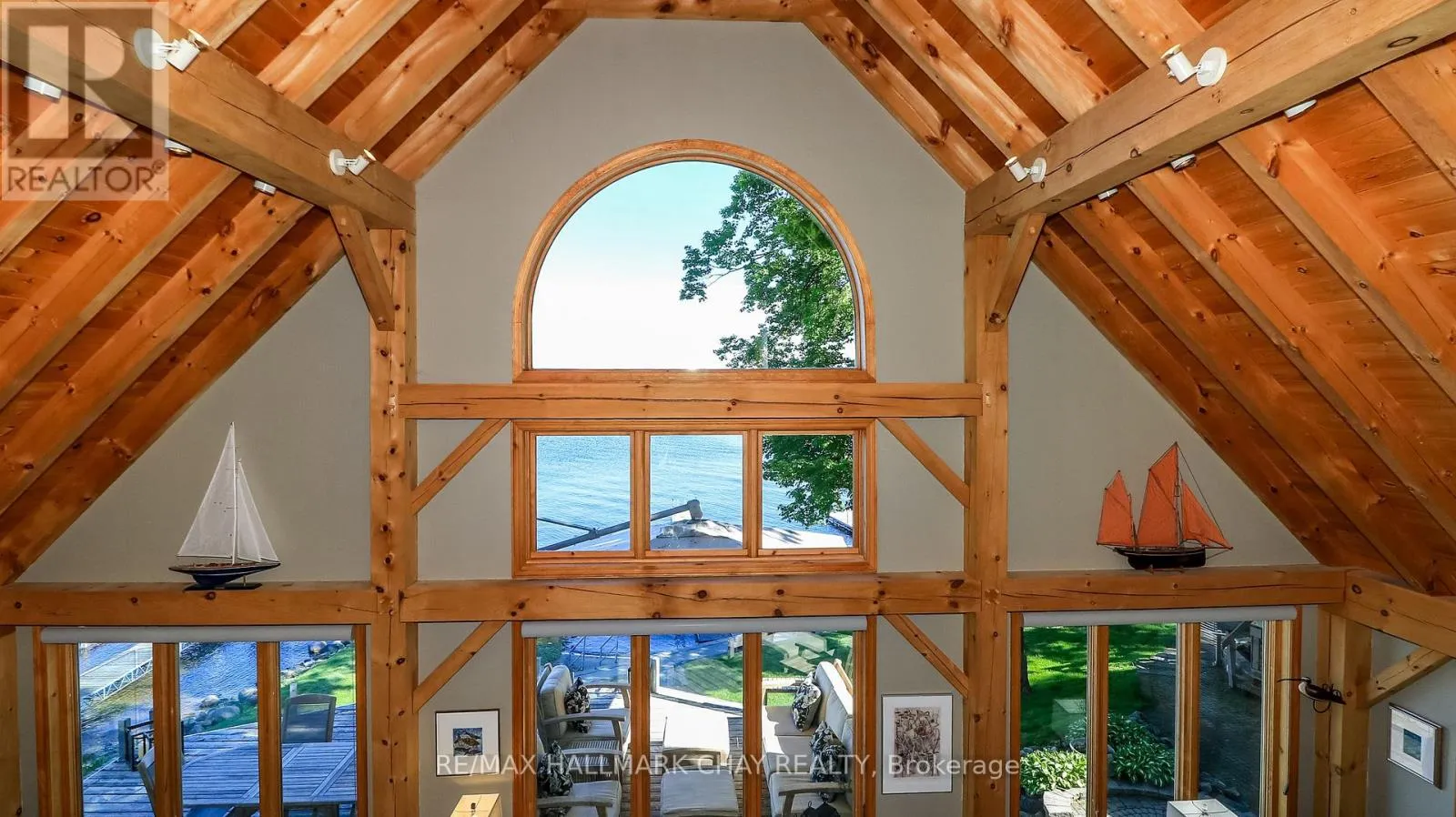 Cathedral post and beam great room with arched window overlooking Georgian Bay